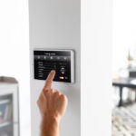 Best smart thermostats 2026 - five WiFi smart thermostats on a wall with energy savings display and smartphone app control